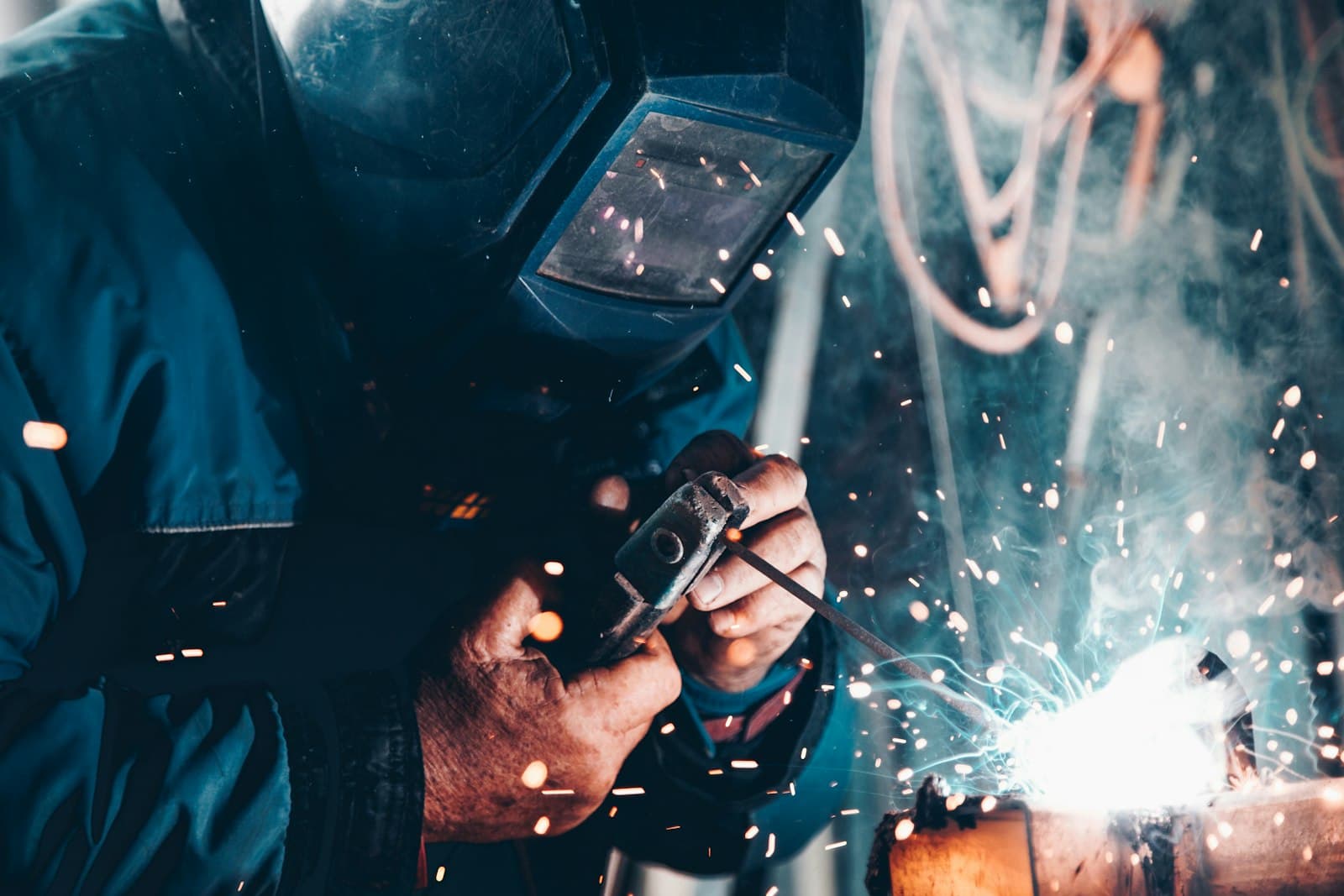 Welder working on site in full protective equipment